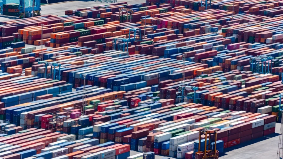 A bustling port with colorful cargo containers, aerial view showcasing global trade.
