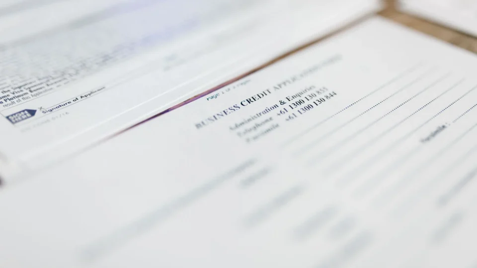 Focused image of business credit application papers, ideal for finance themes.