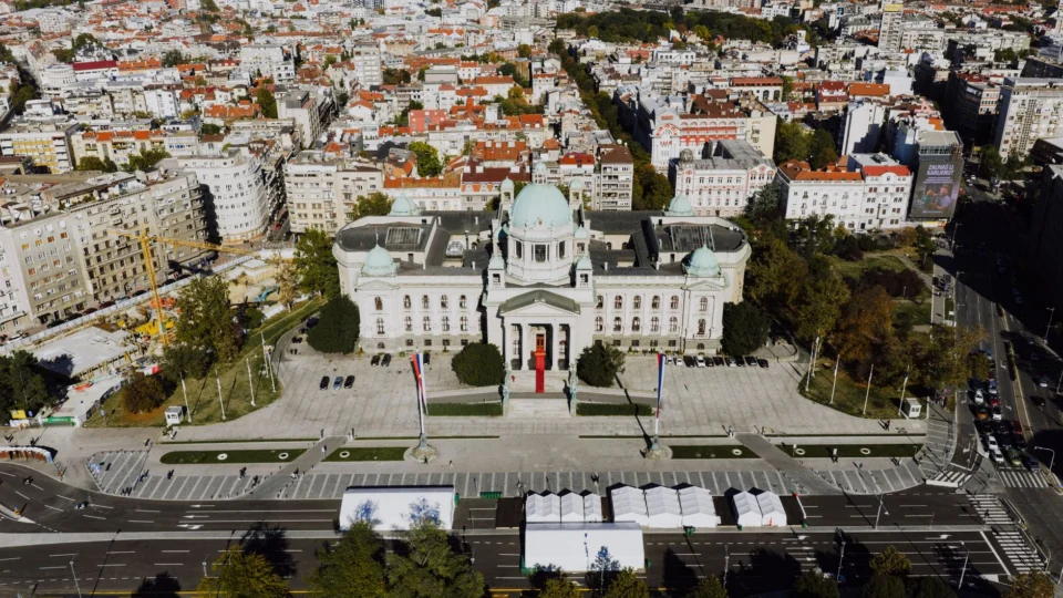 Drone shot of the National Assembly building in Belgrade, Serbia’s architectural landmark surrounded by cityscape.