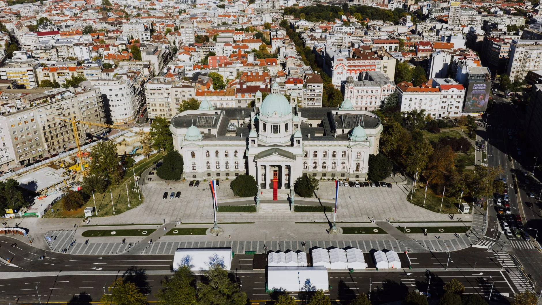 Drone shot of the National Assembly building in Belgrade, Serbia’s architectural landmark surrounded by cityscape.