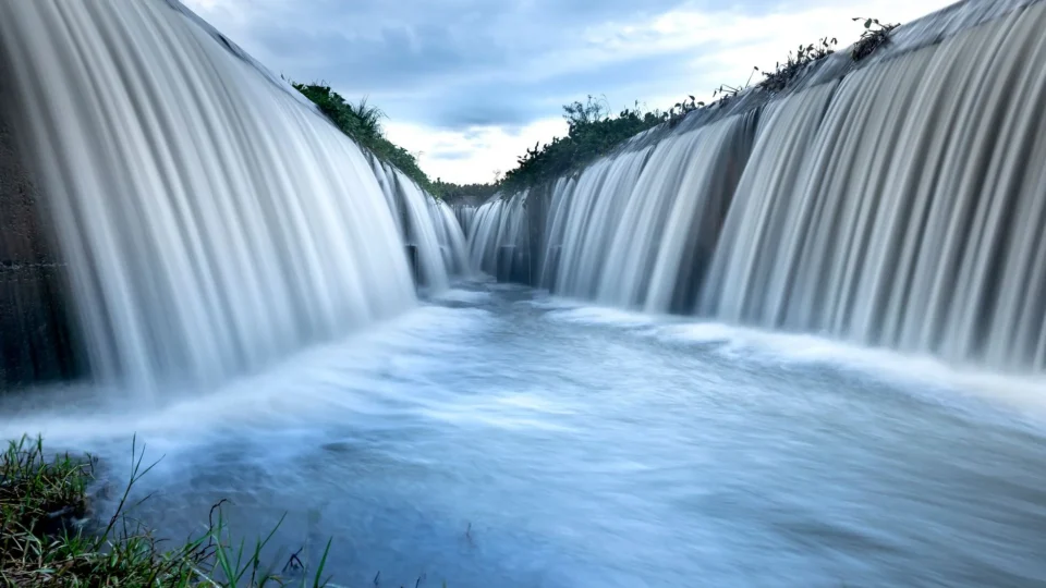 A stunning view of cascading water over a dam, showcasing natural beauty and movement.
