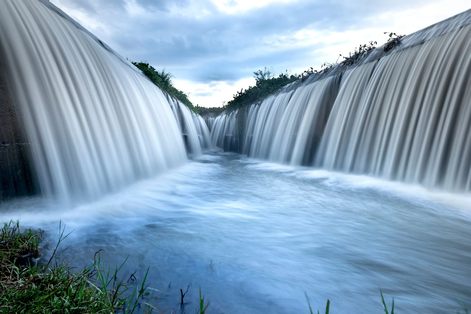 A stunning view of cascading water over a dam, showcasing natural beauty and movement.