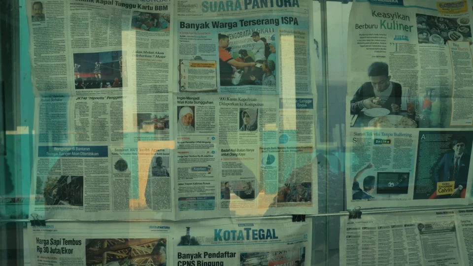 Detailed view of various newspapers on display in Jakarta, Indonesia.