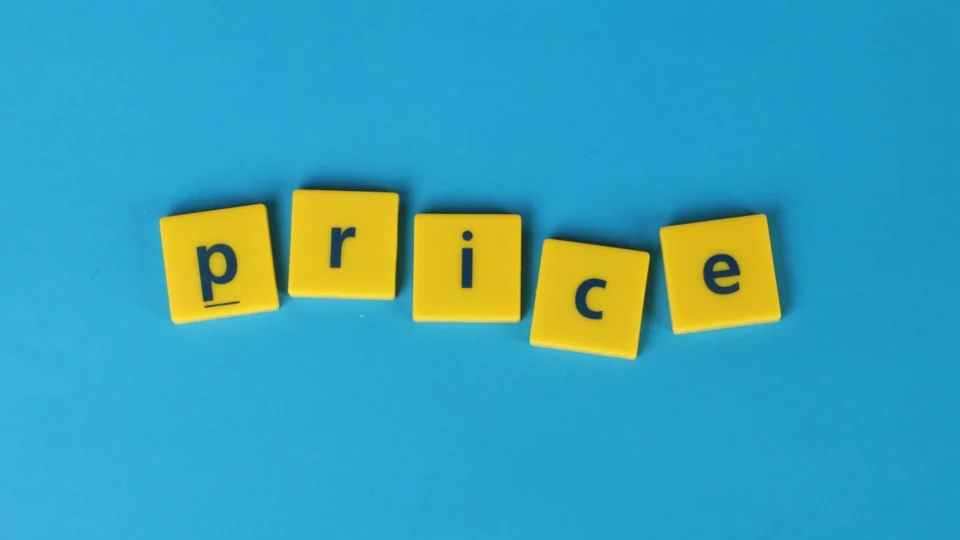 Yellow letter tiles spell the word 'price' against a vibrant blue backdrop, ideal for business concepts.