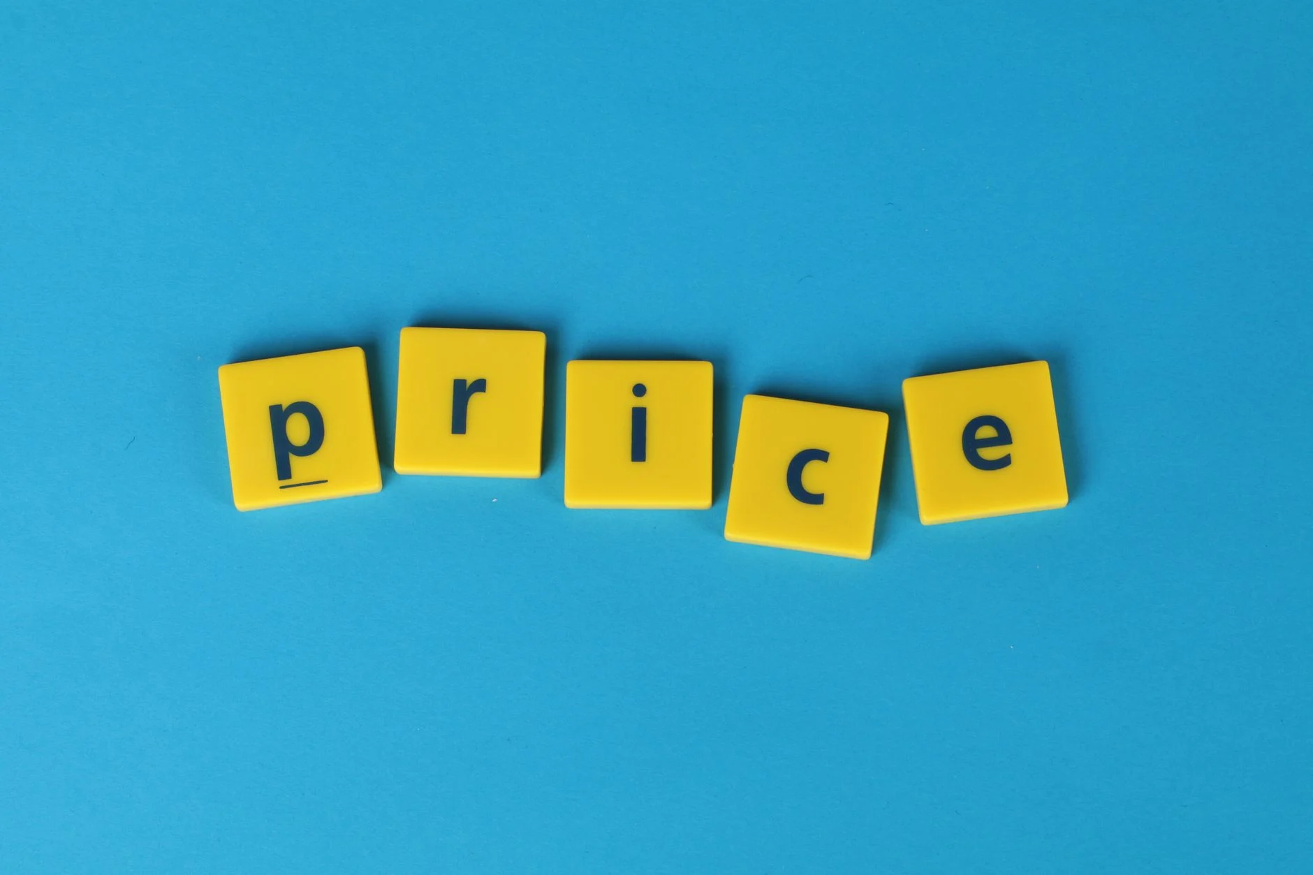 Yellow letter tiles spell the word 'price' against a vibrant blue backdrop, ideal for business concepts.