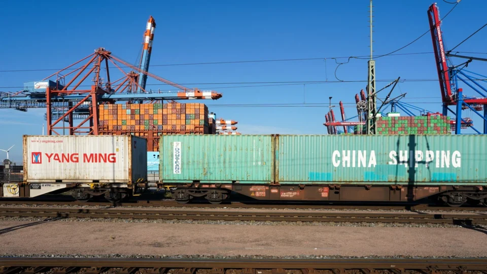 Cargo containers on a train at Hamburg port showcasing global trade infrastructure.