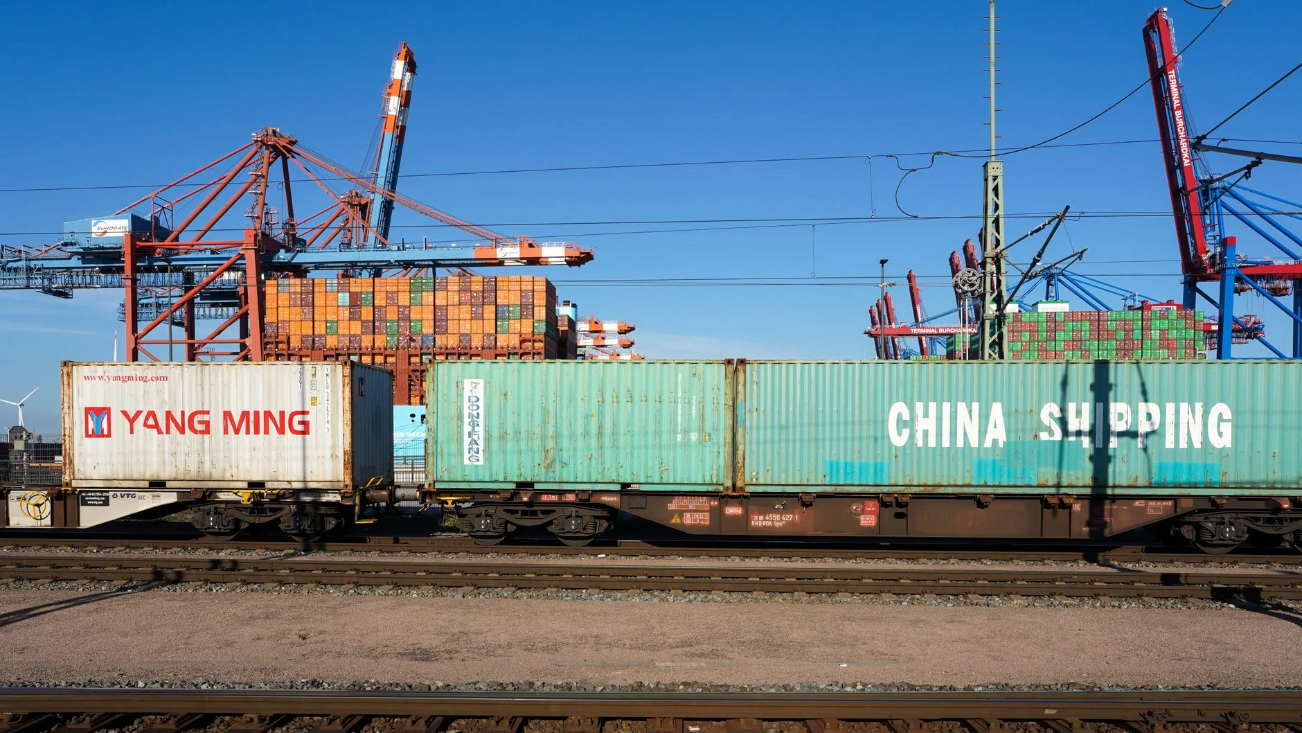 Cargo containers on a train at Hamburg port showcasing global trade infrastructure.