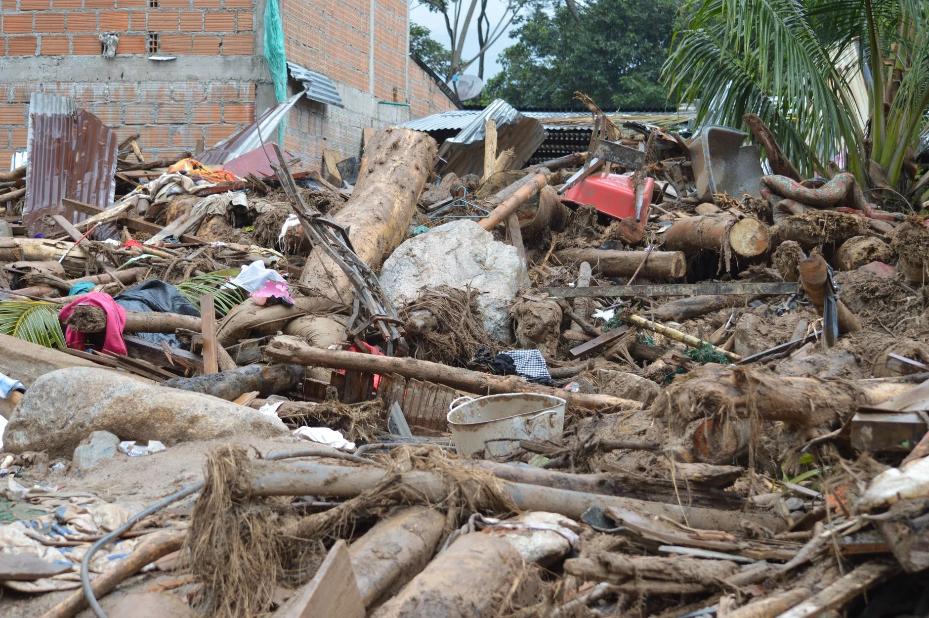 Destruction in Mocoa, Colombia due to natural disaster. Damaged structures and debris.