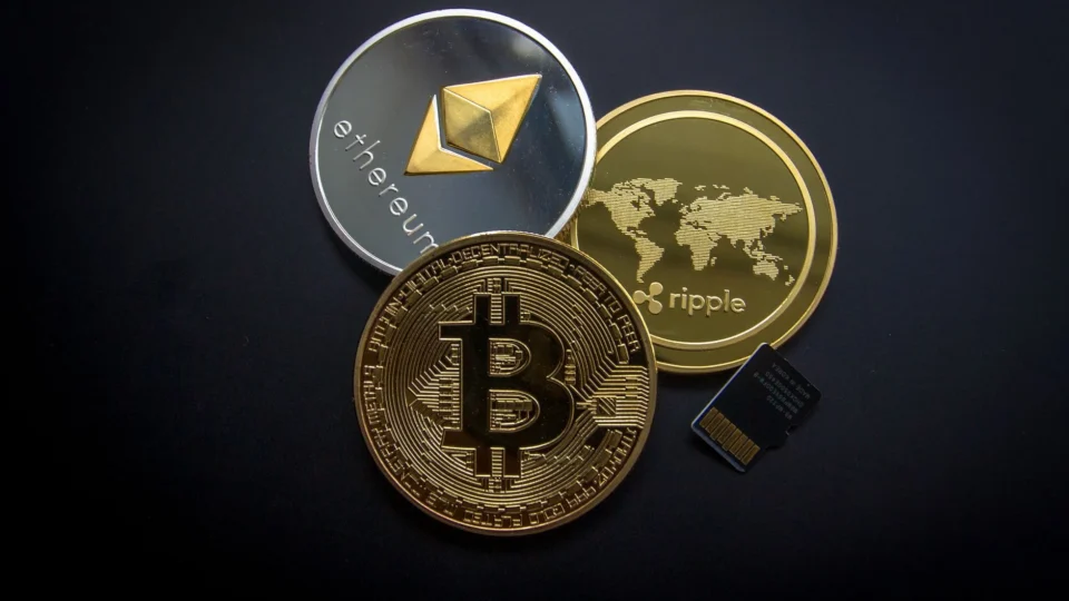 A striking image of Bitcoin, Ethereum, and Ripple coins illustrating modern digital currency.
