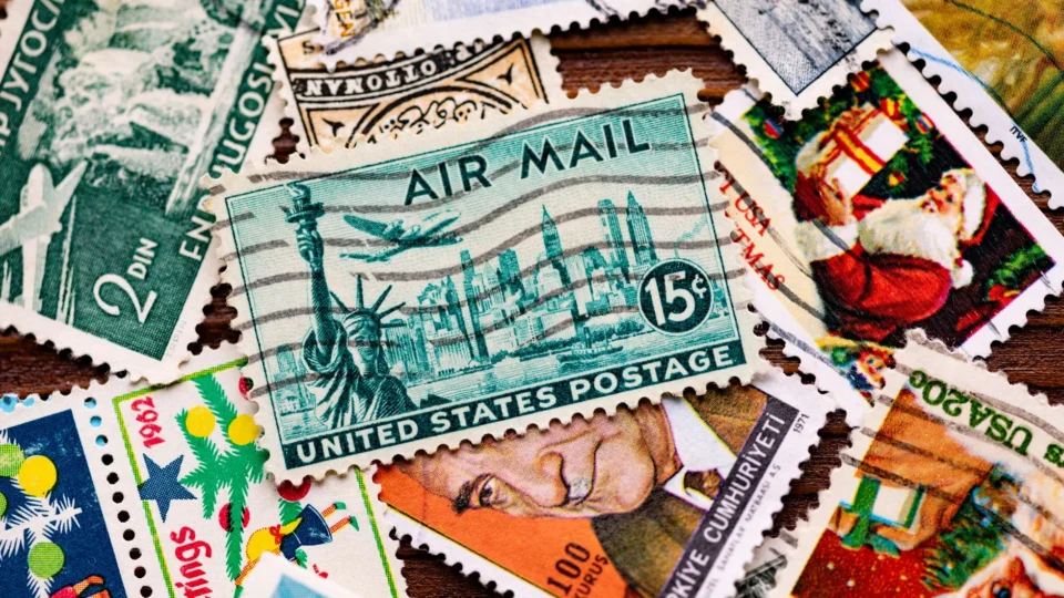 A collection of vintage postage stamps featuring iconic designs, including the Statue of Liberty.