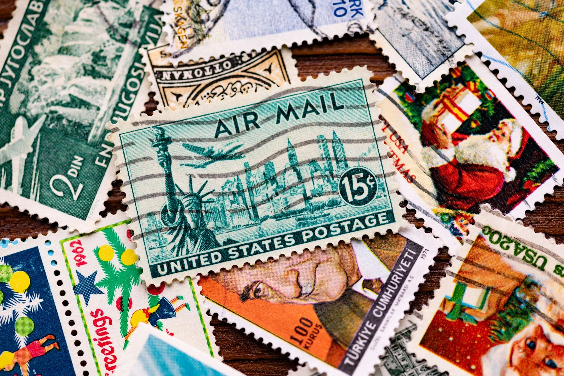 A collection of vintage postage stamps featuring iconic designs, including the Statue of Liberty.