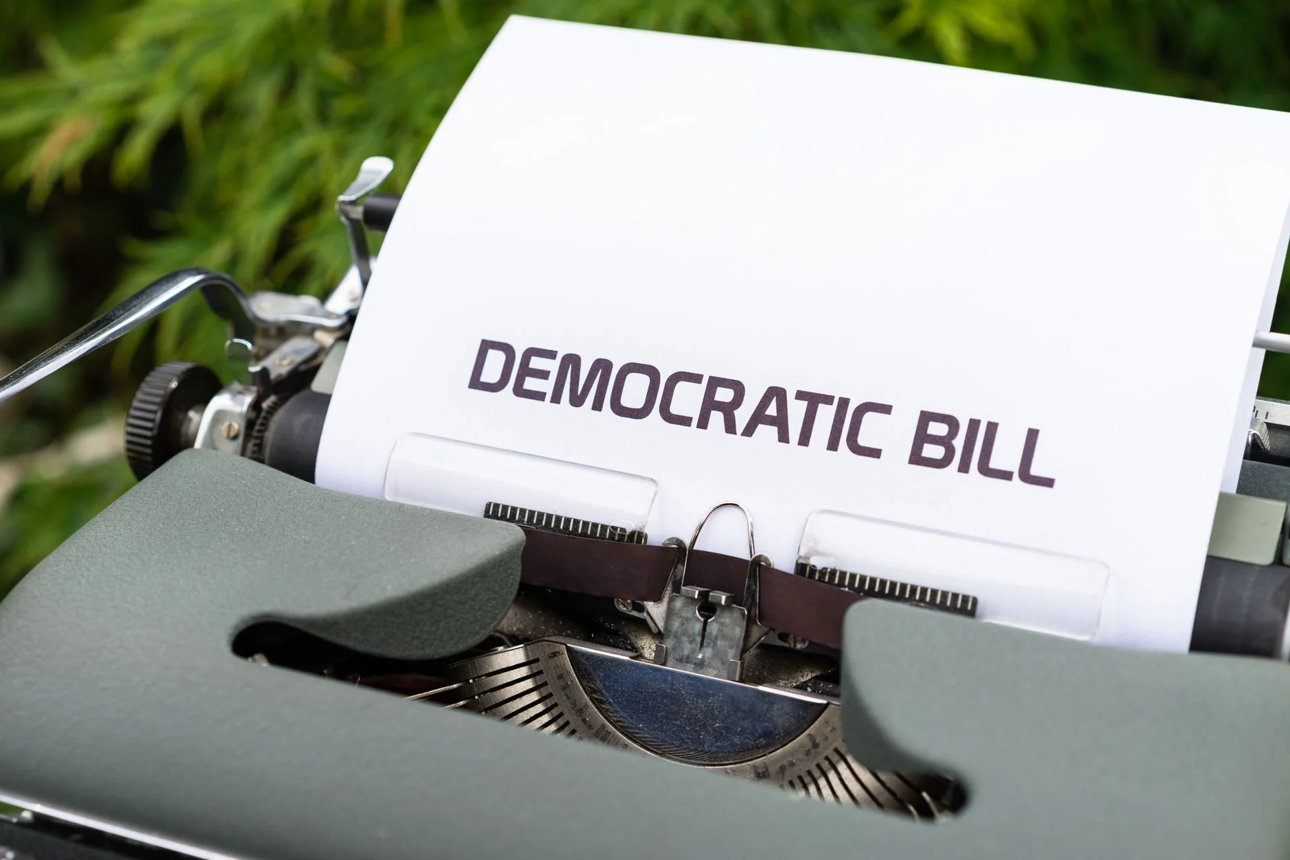 Close-up of a vintage typewriter printing a democratic bill, symbolizing government and legislative concepts.