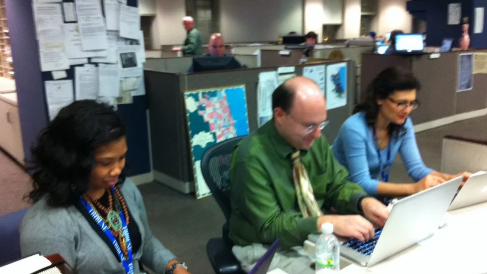 Journalists working at computers in the Chicago Tribune newsroom