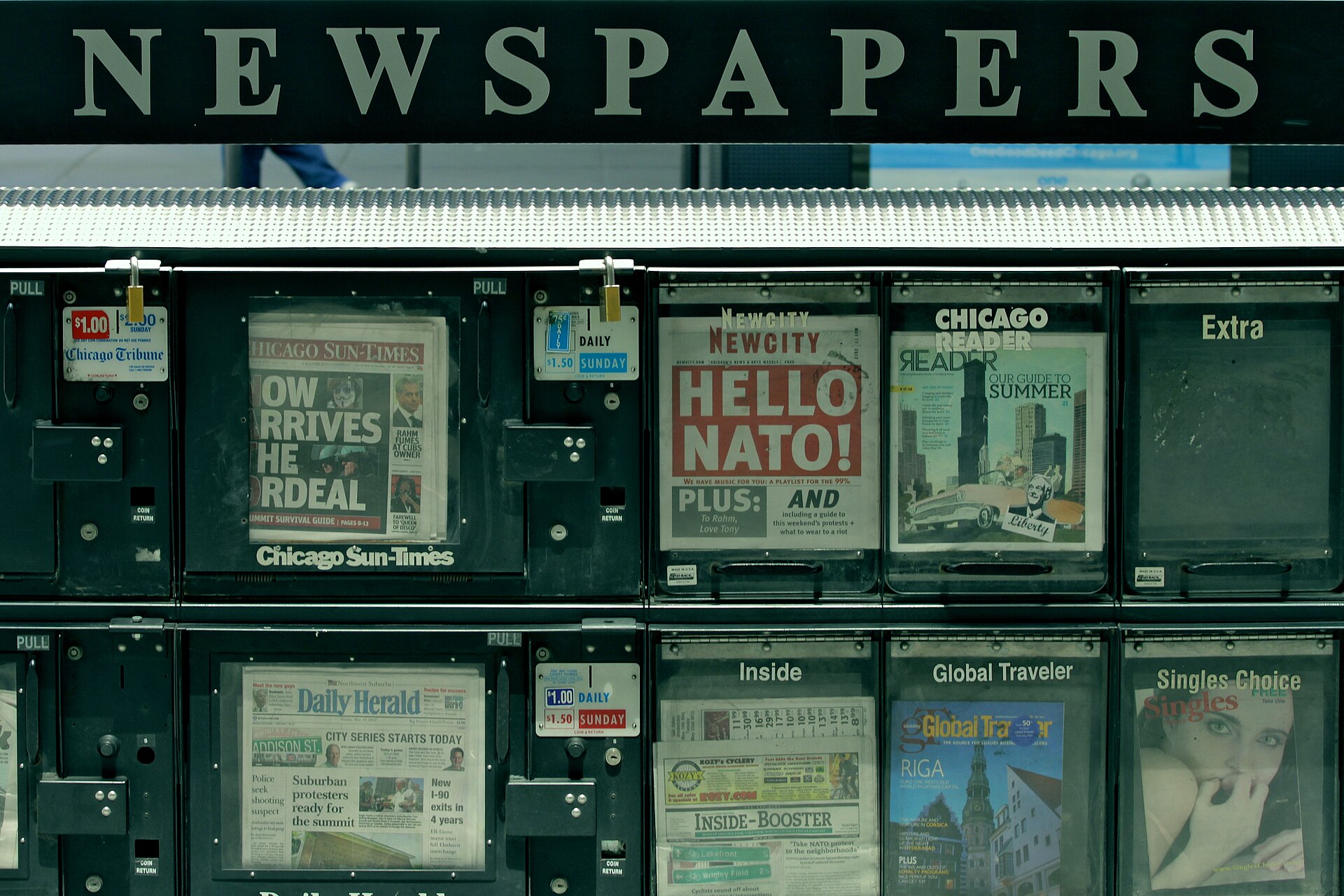 Street newsstand stocked with newspapers and magazines
