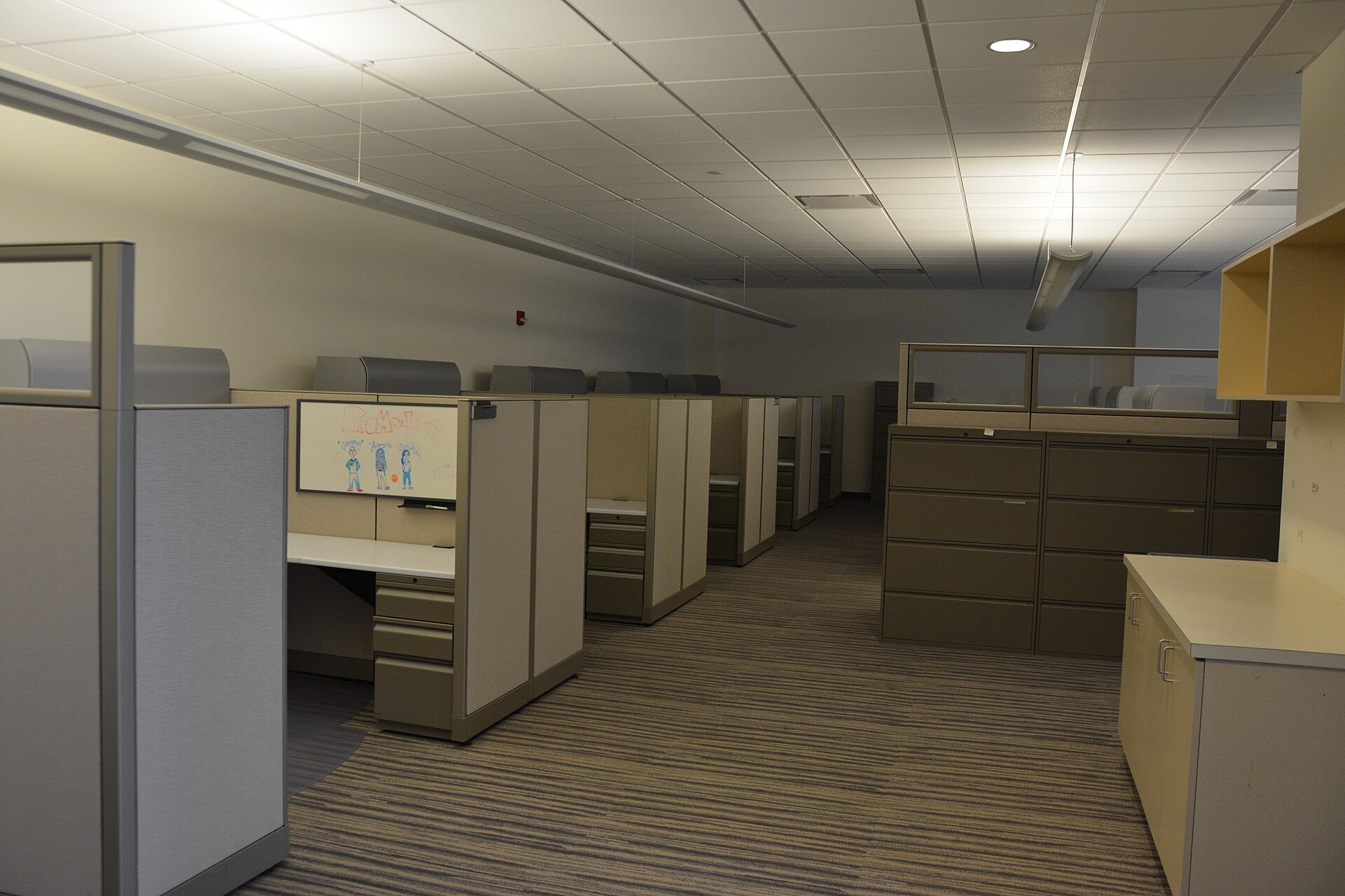 Empty open-plan office with vacant desks and chairs