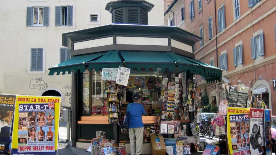Street newsstand stocked with newspapers and print magazines