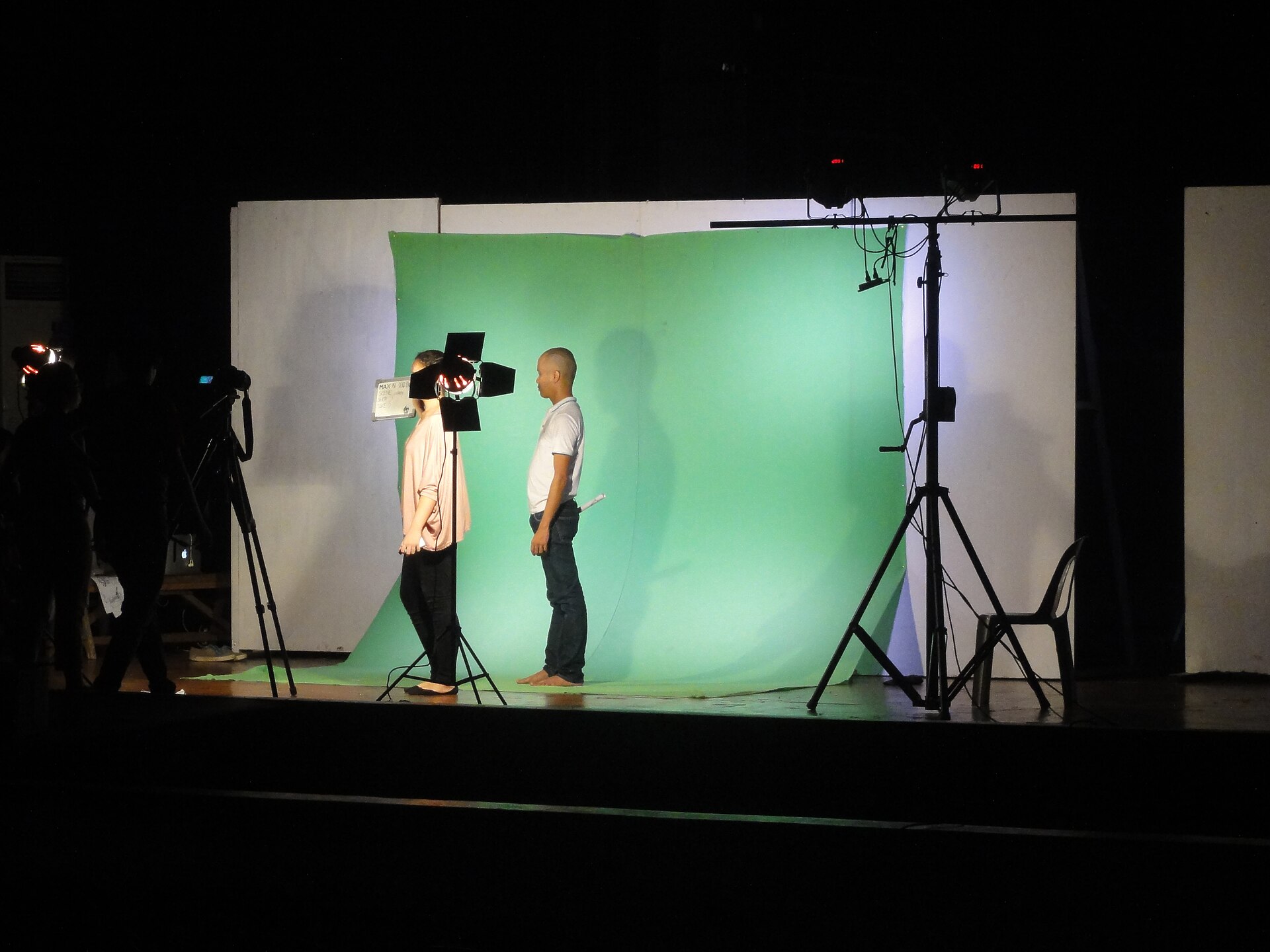 A green-screen chroma-key video studio setup