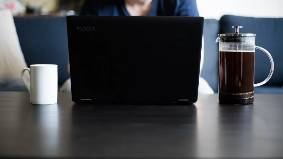 Laptop and coffee cup on a home desk