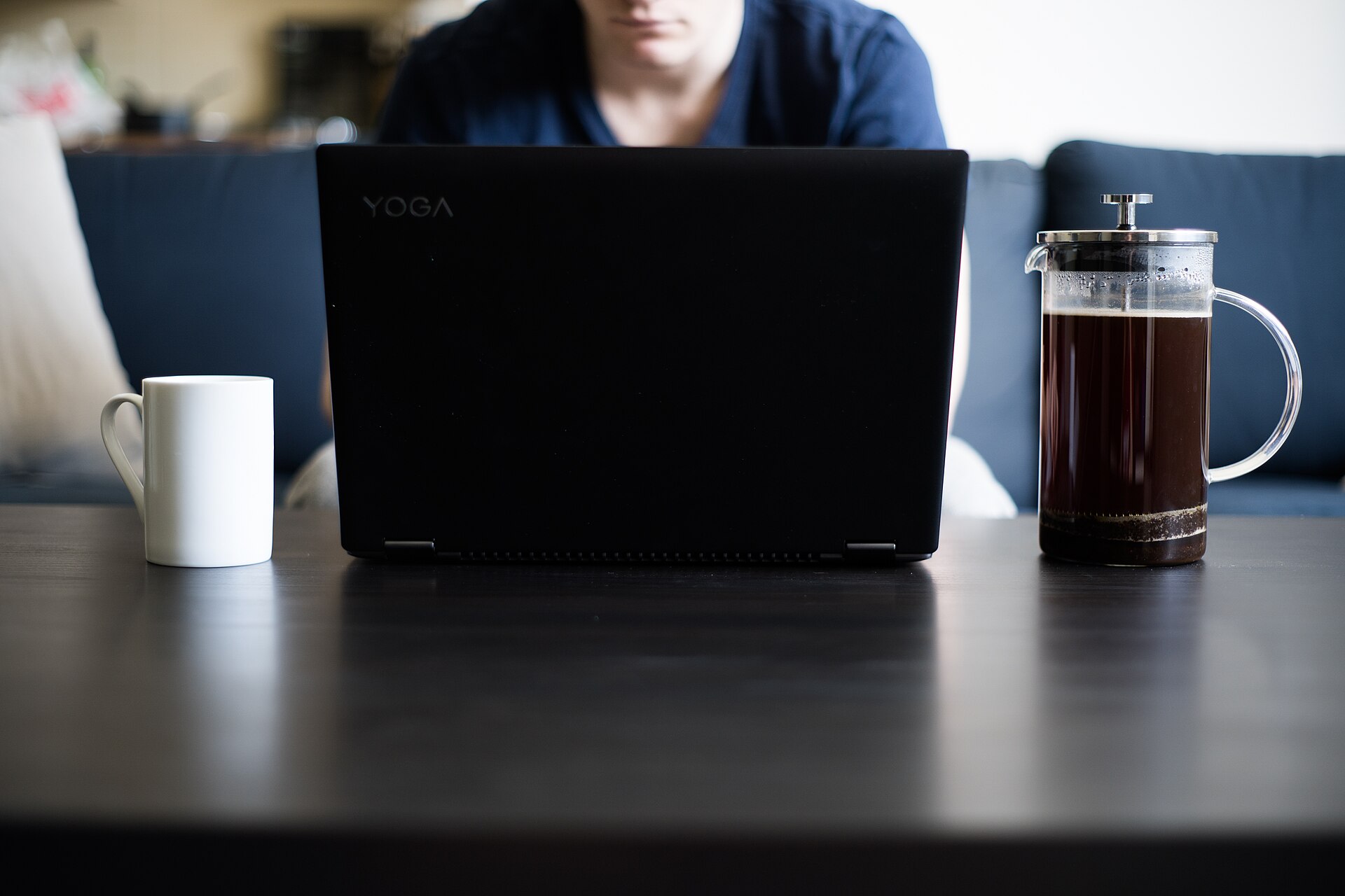 Laptop and coffee cup on a home desk