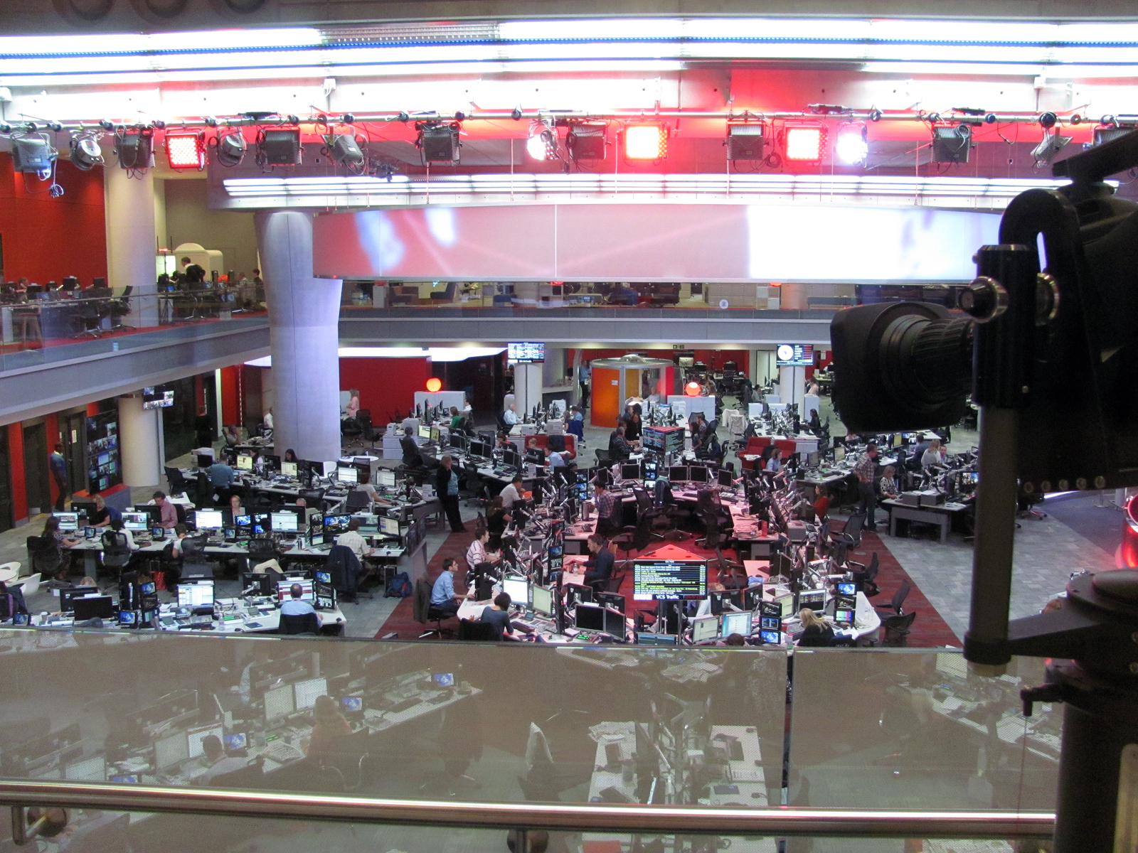 Television newsroom with cameras and journalists' desks
