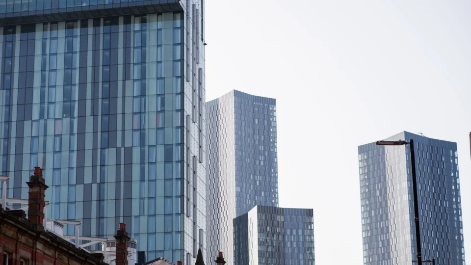 A view of modern skyscrapers in Manchester, showcasing urban architecture and city life.
