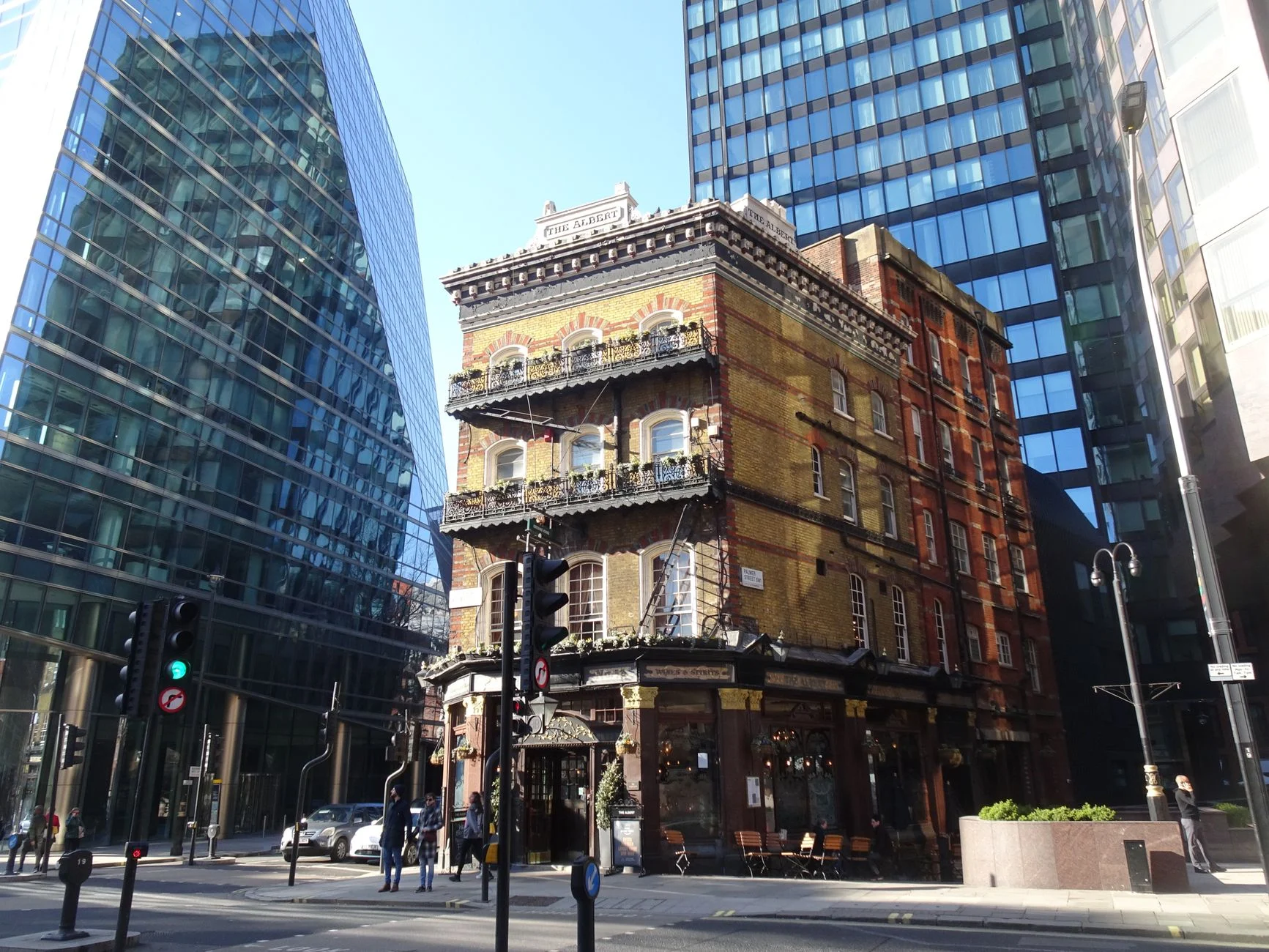 A historic pub in London juxtaposed with modern skyscrapers, capturing the city's blend of tradition and progress.