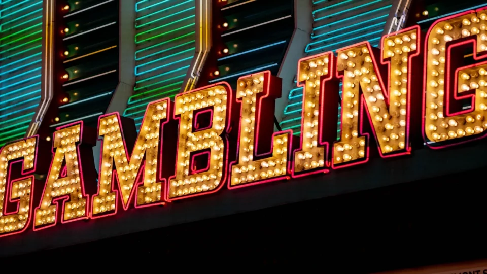 Bright neon sign displaying 'Gambling' with vibrant lights at night in Las Vegas.