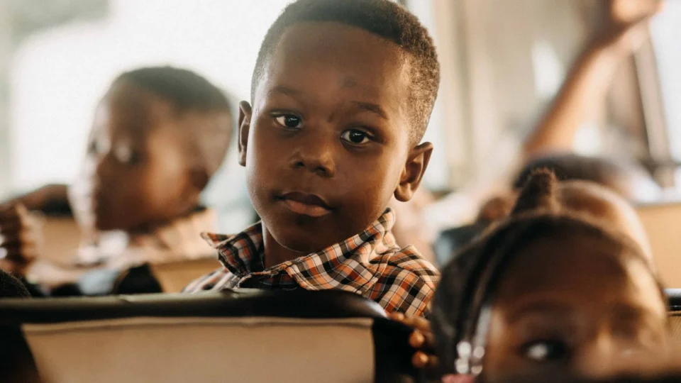 Children attentively riding a school bus, highlighting educational themes and travel.