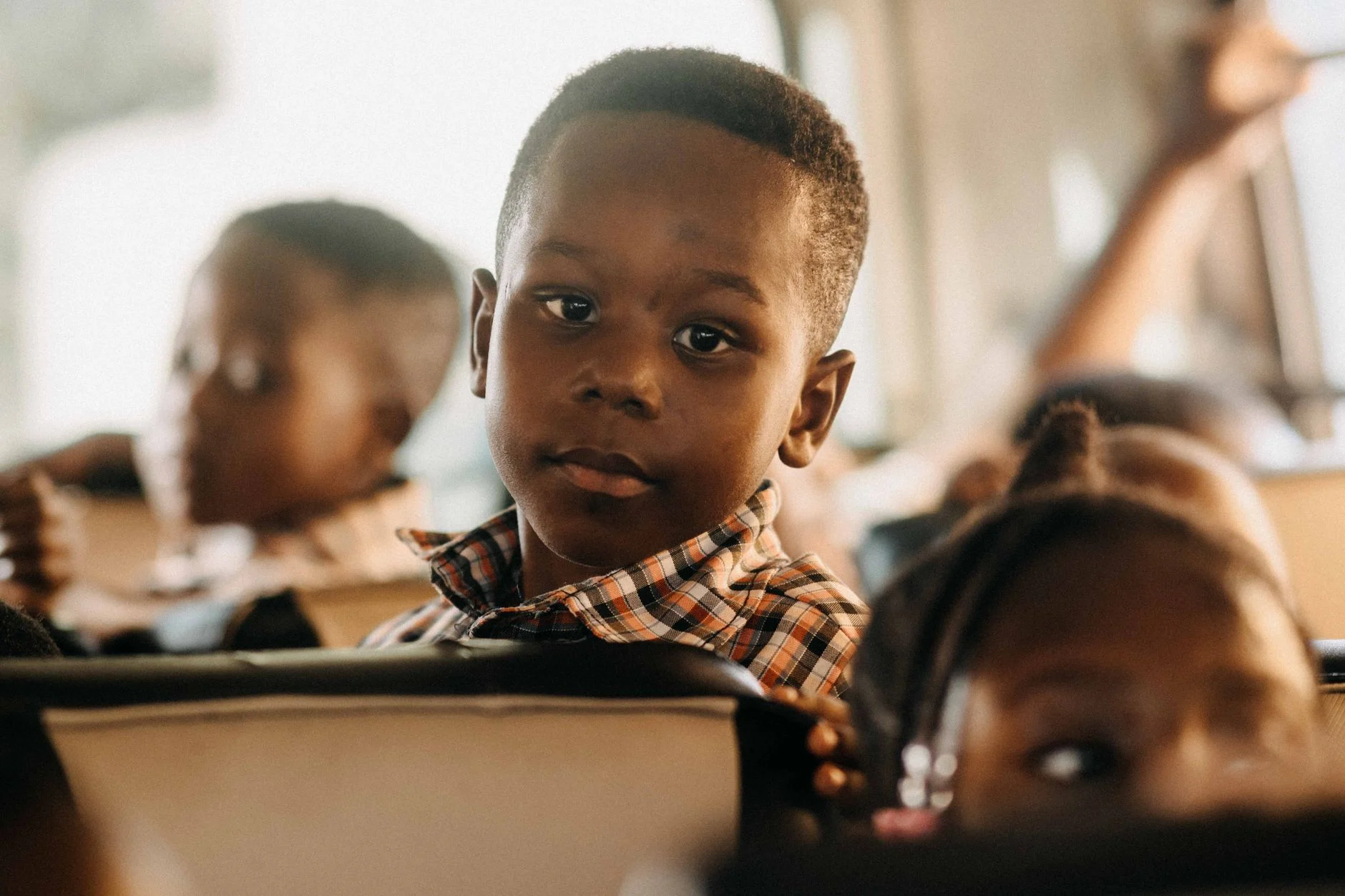 Children attentively riding a school bus, highlighting educational themes and travel.