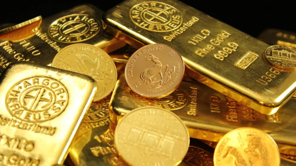 A detailed image of gold bars and coins symbolizing wealth and financial investment.