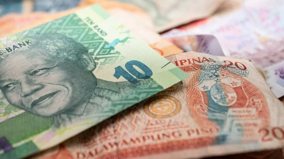 A detailed image featuring South African rand and Philippine pesos, highlighting cultural diversity in currency.