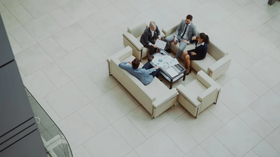 Aerial view of a group business meeting in a modern office setting.