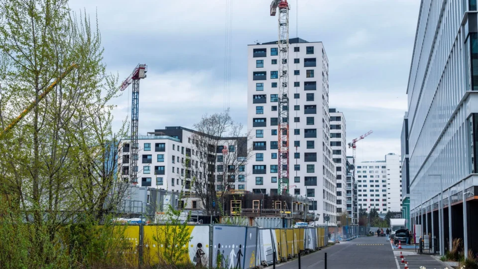 High-rise buildings and cranes in an urban construction site. Modern architecture.