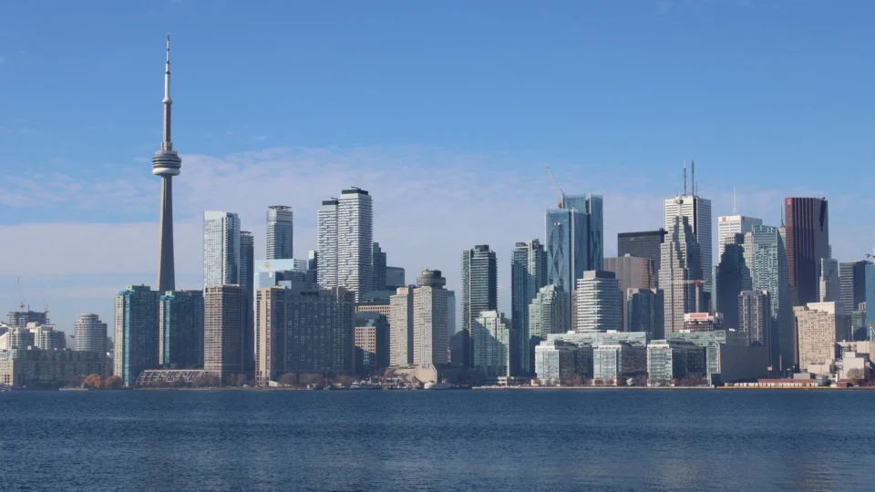 Capture of Toronto's bustling skyline with the iconic CN Tower on a clear day.