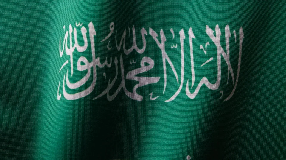 Detailed close-up of the Saudi Arabian flag showcasing the elegant Arabic script and vibrant green color.