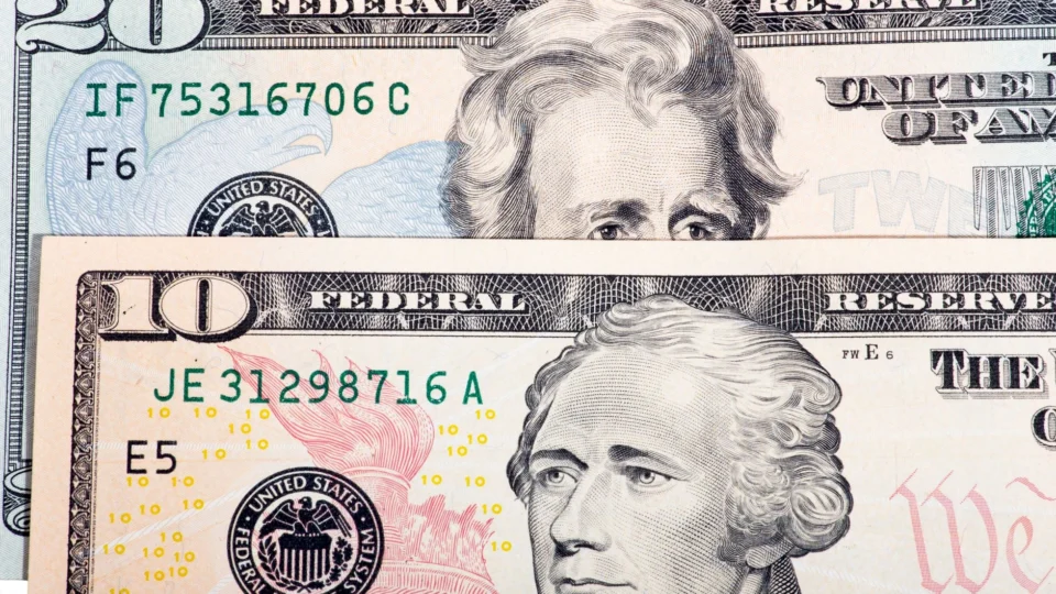 Detailed view of US ten and twenty dollar bills, highlighting design and texture.