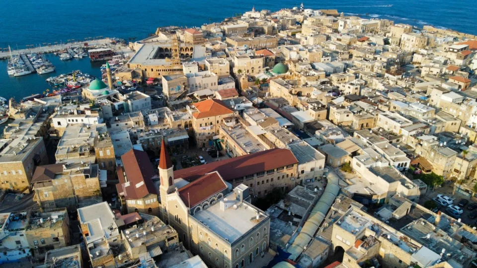 Drone view capturing the historic architecture of Acre, Israel with the sea backdrop.