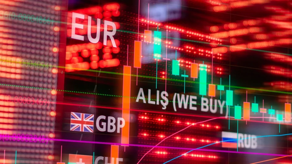 Dynamic forex trading concept with currency symbols and candlestick chart illuminated on screen.