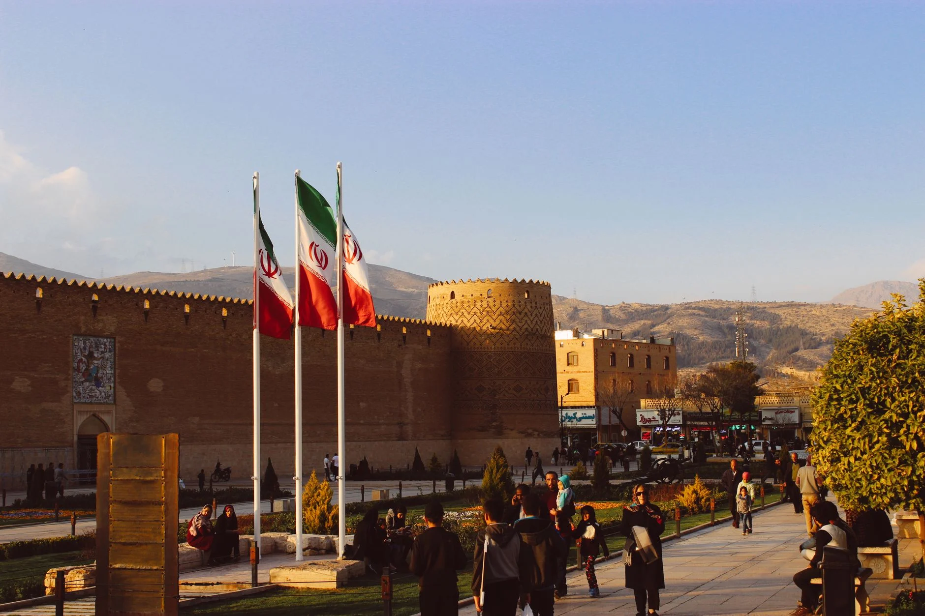 Karim Khan Citadel with Iranian flags in Shiraz, Iran at sunset.