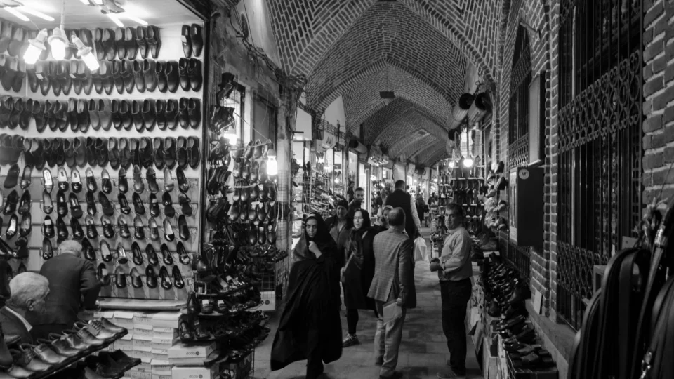 Black and white photo capturing lively market in Tabriz, Iran.