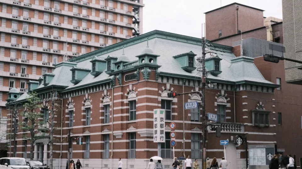 A European-style historic building in a bustling urban area of Kyoto, Japan.