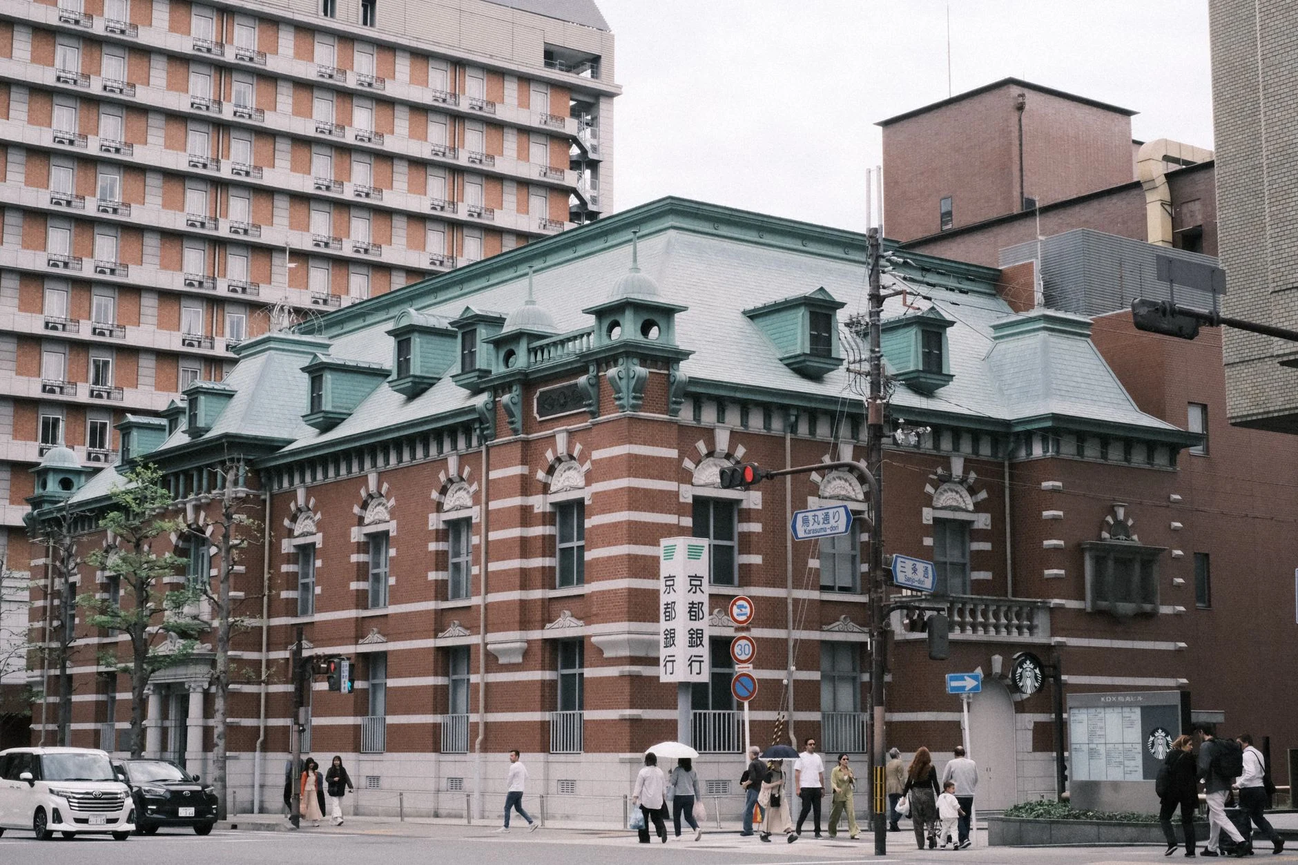 A European-style historic building in a bustling urban area of Kyoto, Japan.