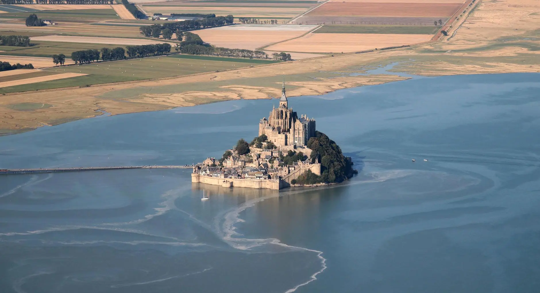 Stunning aerial view of Mont Saint-Michel in Normandie, a famous UNESCO World Heritage site.