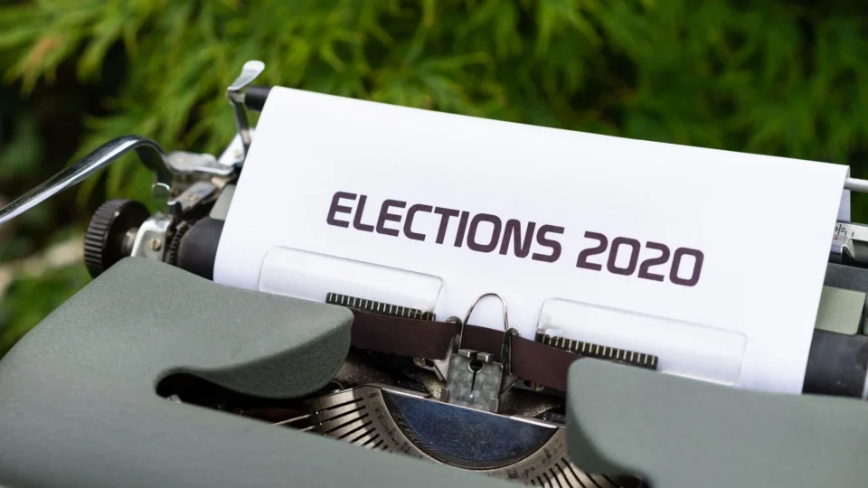 Close-up of a typewriter typing 'Elections 2020' outdoors.