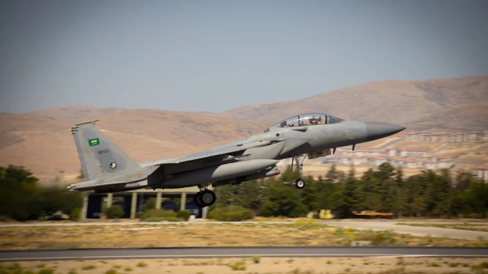 F-15 military jet taking off from Konya runway with Saudi Arabian markings.