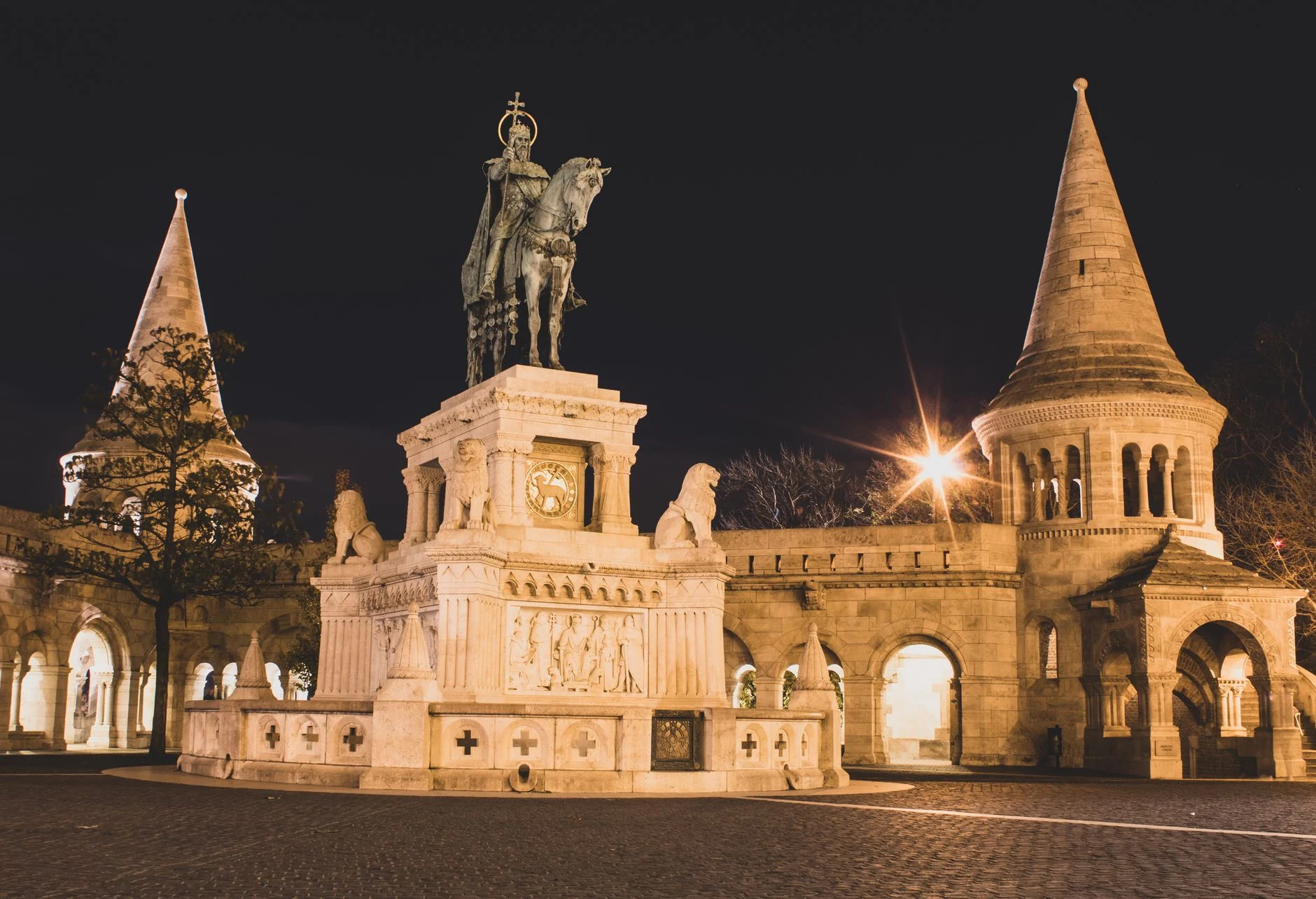 The stunning Fisherman's Bastion in Budapest illuminated at night, showcasing its iconic towers and statues.