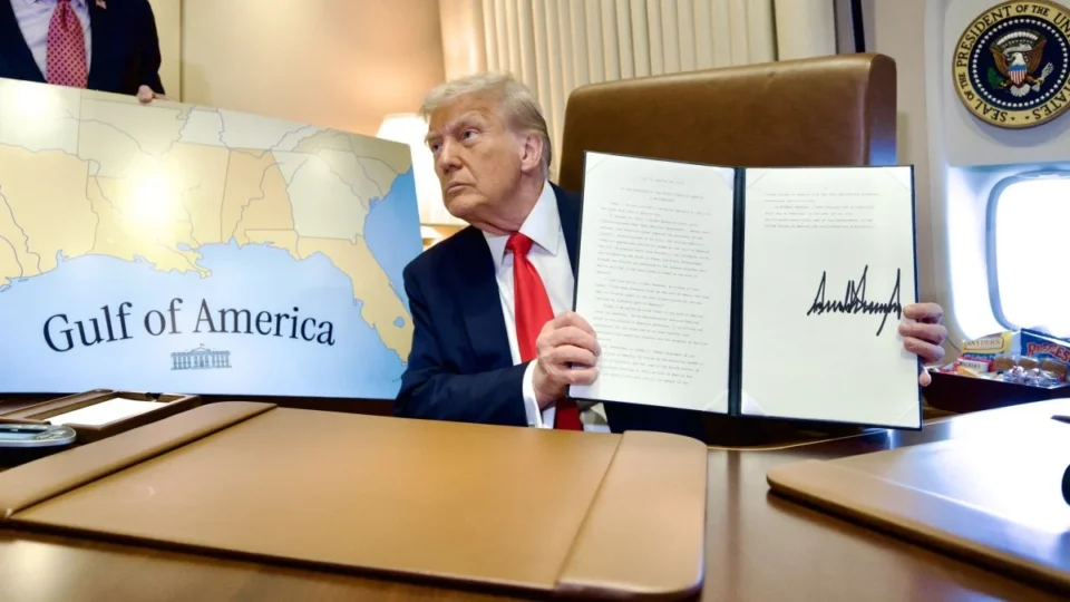 Donald Trump on Air Force One beside a map during a flight