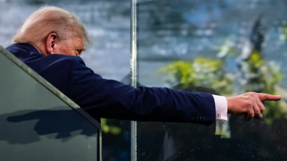 Donald Trump points from the reviewing area at the U.S. Army parade