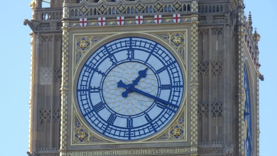 Close-up of the iconic Elizabeth Tower clock face in London, showcasing intricate design.