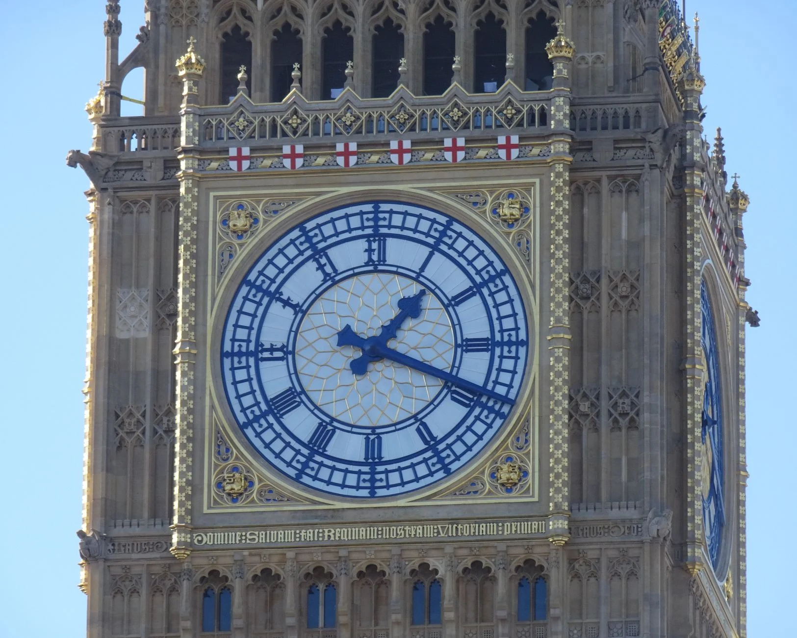 Close-up of the iconic Elizabeth Tower clock face in London, showcasing intricate design.